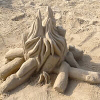 Sand sculpture of campfire on the beach in Frisco NC.