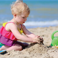Child playing on the beach in Frisco NC.